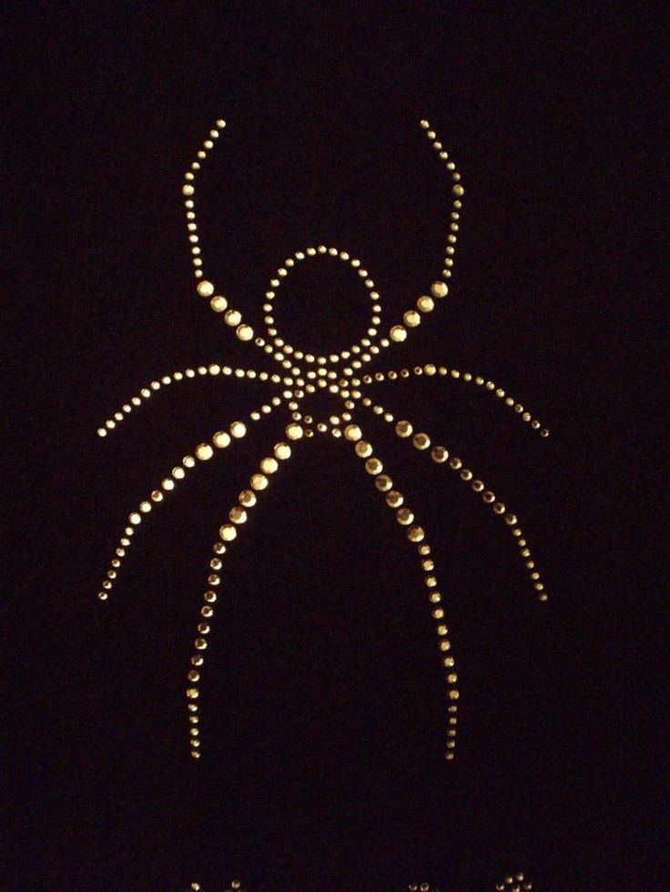 a large spider made out of pearls in the dark