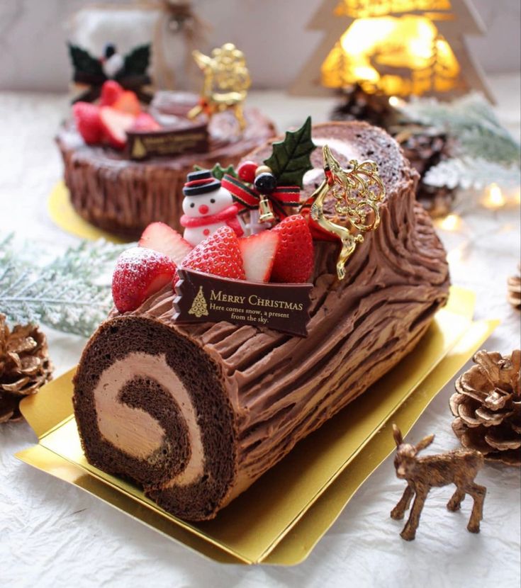 there is a piece of chocolate cake on the plate with strawberries and christmas decorations