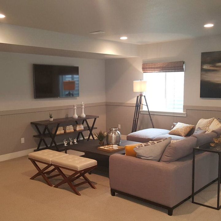 a living room filled with furniture and a flat screen tv mounted to the side of a wall