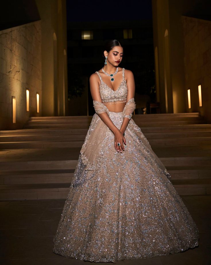 This champagne lehenga set features all over assorted sequin and crystal embroidery. The blouse comes with tassels and the outfit is paired with a matching net dupatta.From Seema Gujral's Celeste collection.DELIVERY TIMEPlease allow 8-12 weeks for your outfit to arrive.FABRIC DETAILSNet.Professional cleaning only. Champagne Lehenga, Shimmer Lehenga, Indian Reception Outfit, Sequins Lehenga, Sequin Lehenga, Seema Gujral, Reception Outfits, Engagement Lehenga, Sangeet Outfit