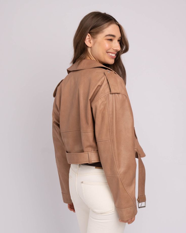 A cropped leather jacket is a foolproof way to polish off an outfit, without feeling weighed down in bulk. The shorter hem of our Marlin leather jacket for women is perfect for experimenting with proportions, whether paired with high-waisted jeans for daily wear or a mini skirt for evenings out. Handcrafted from the finest lamb leather, this cropped moto jacket only improves with age. Complete with an off-center zipper closure, belt detail, zipper pockets, and a bold collar adorned with silver h Chic Brown Cropped Jacket, Brown Cropped Outerwear For Work, Cropped Brown Outerwear For Work, Fall Cropped Leather Biker Jacket, Leather Cropped Biker Jacket For Fall, Cropped Leather Biker Jacket For Fall, Chic Brown Leather Cropped Jacket, Designer Cropped Leather Jacket For Work, Cropped Leather Jacket For Work