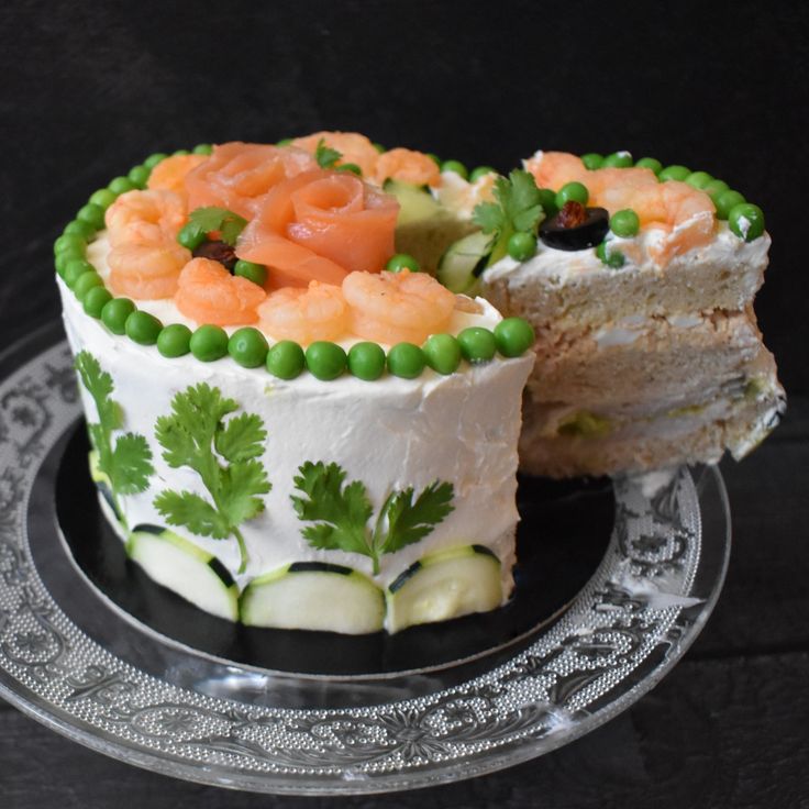 there is a cake that has been decorated with carrots and cucumbers on it