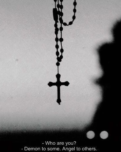 a black and white photo with a cross hanging from it's side