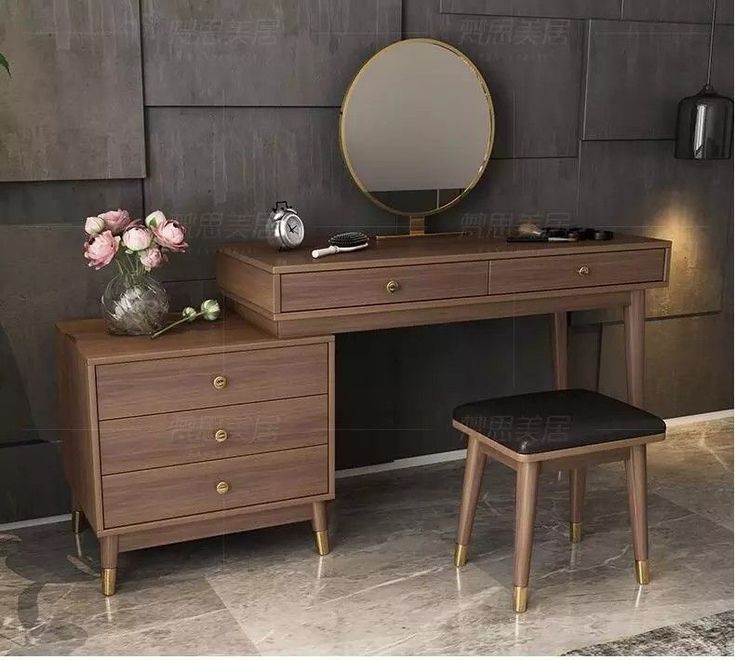 a desk with a mirror, stool and flower vase on the table in front of it