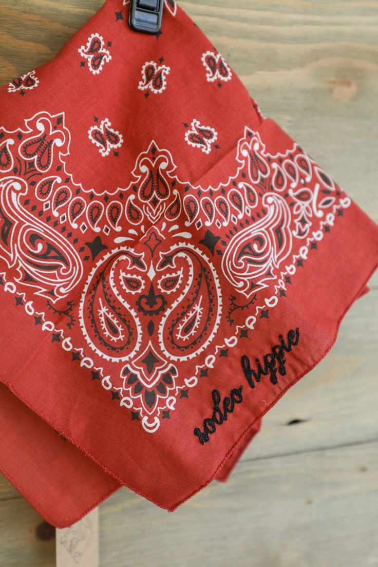 a red bandana hanging on a wooden wall