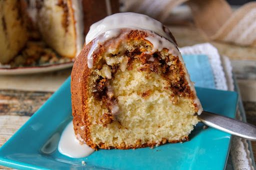 a bundt cake with icing on a blue plate