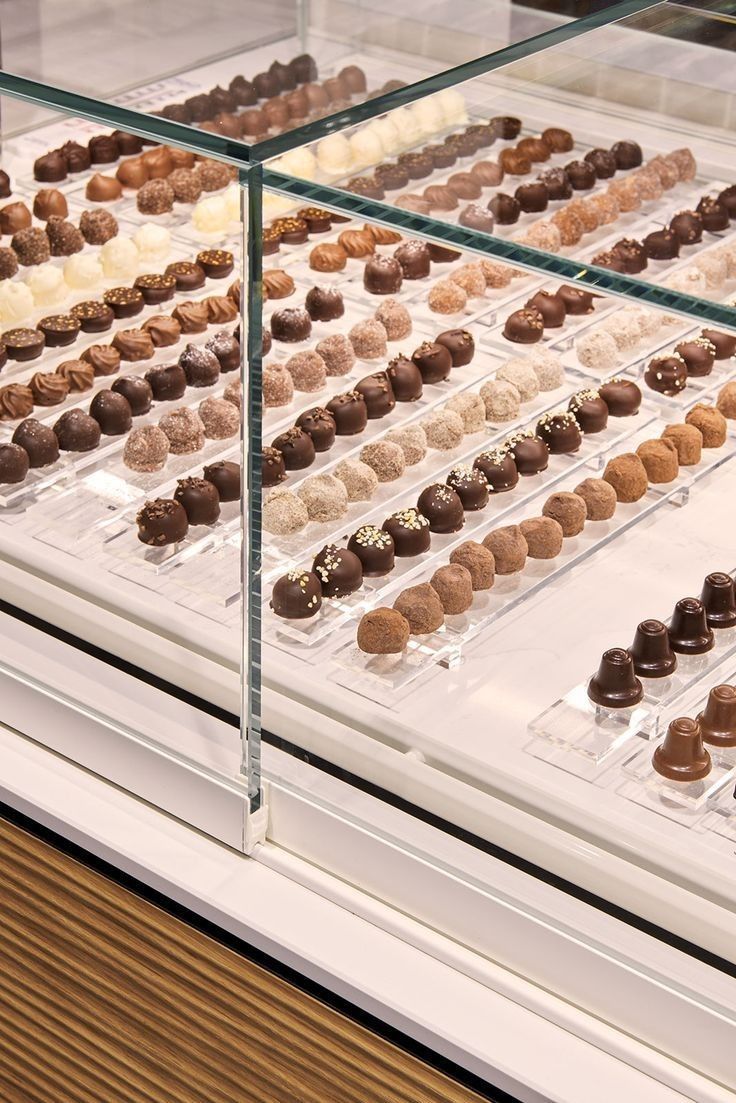 a display case filled with lots of different types of chocolates on top of each other