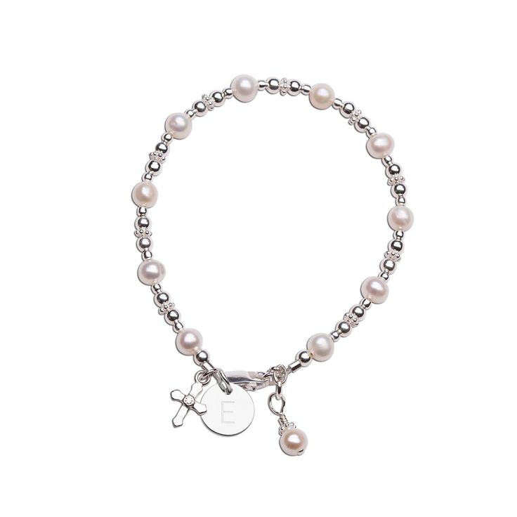 This is a timeless keepsake bracelet designed and hand-beaded in the USA.  This is made using only the finest materials such as 100% sterling silver components, freshwater sea pearls, and adorned with an intricate sterling silver cross charm.  This comes boxed in a beautiful gift box ready for gifting and makes a special keepsake for her special first communion day, Baptism, or Christening! Make it extra special by adding her initial charm so it's special just for her! Each bracelet has a grow-with-me extension chain for a perfect fit.  Please see sizing chart below: SM (0-12 months) 4 - 4.5 inches MED (1-5 years) 5 - 5.5 inches LG (6-12 years) 6 - 6.5 inches Matching Earrings:  https://etsy.me/2I8MFE9 Matching Necklace:  https://etsy.me/2IpG0Vi FREE STANDARD SHIPPING - ships within 1 busi Silver Beaded Jewelry For Baptism, Adjustable White Gold Bracelets With Pearl Charm, Silver Rosary Bracelet With Round Beads For First Communion, Personalized Sterling Silver Bracelets With Round Beads, Adjustable Sterling Silver Beaded Bracelets With Pearl Charm, Personalized Silver Dainty Pearl Bracelet, Silver Rosary Bracelet With Round Beads For Baptism, Dainty Personalized Silver Pearl Bracelet, Classic Adjustable Jewelry For First Communion