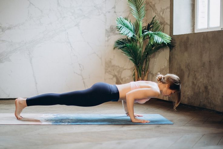 a woman doing push ups on a yoga mat with an inspirational quote above her that reads, take care of your body it's the only place you have to live