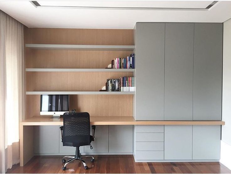 an office area with desk, bookshelf and cabinets