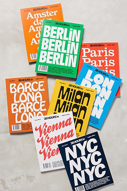 five different magazine covers laying on top of each other in front of a white wall