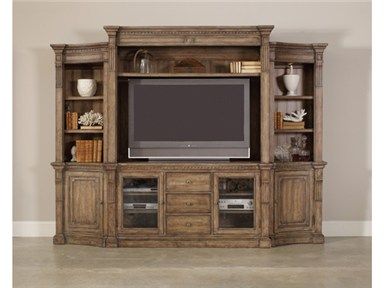 an entertainment center with a large tv on it's stand and shelves in front of the wall