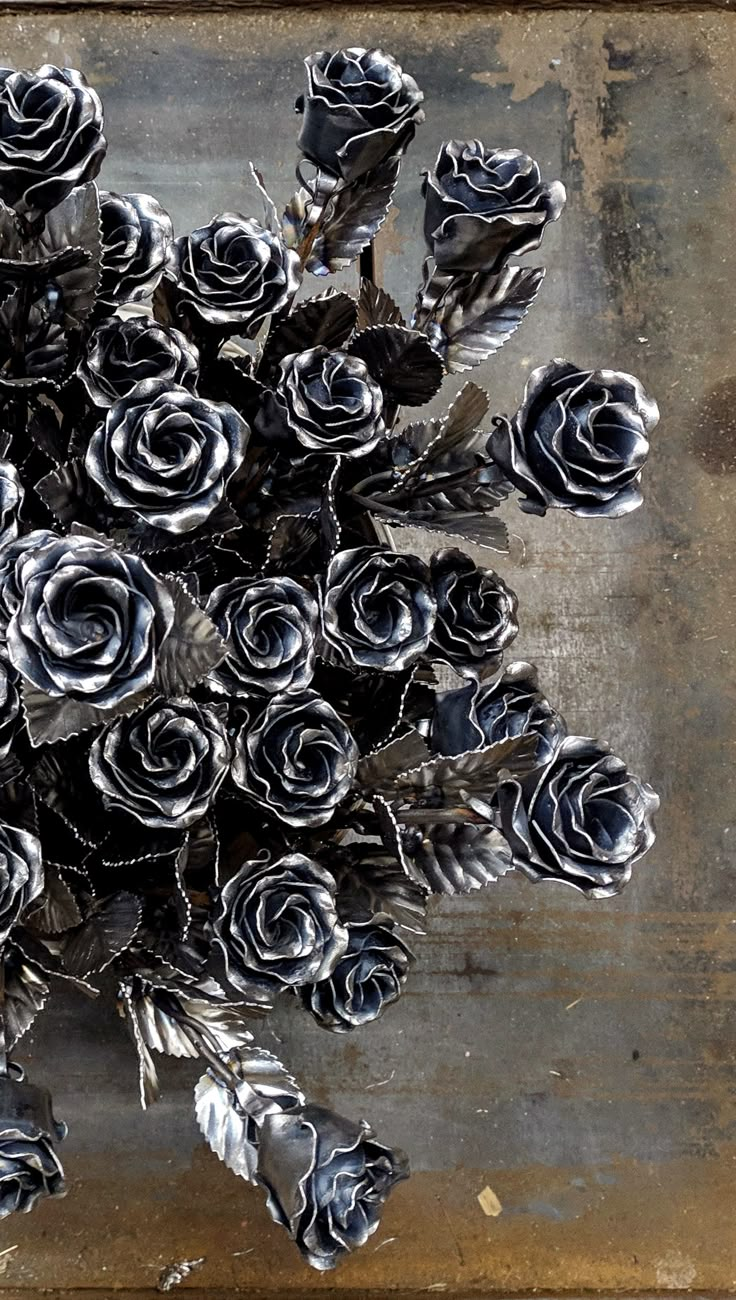 a bunch of black roses sitting on top of a wooden table