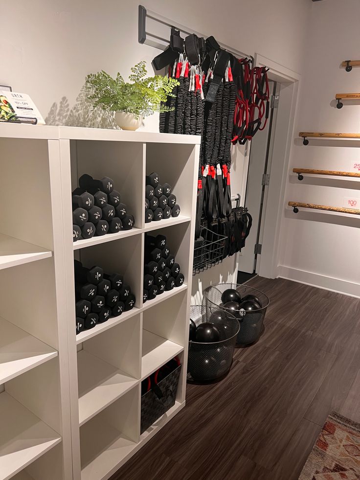 a room filled with pots and pans next to a wall mounted rack full of cooking utensils