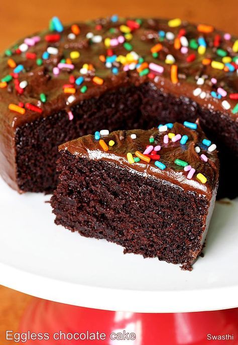 a chocolate cake with sprinkles on a white plate