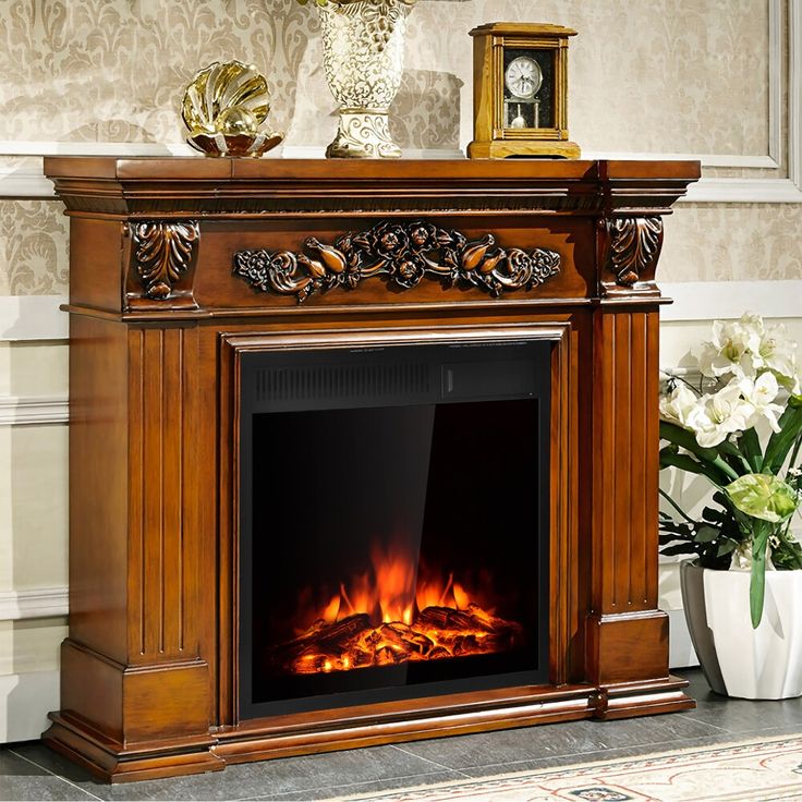 a fireplace with an ornate mantle and fire in it