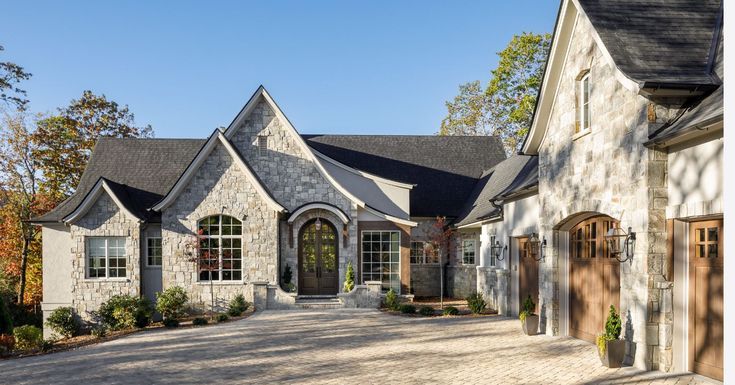 a large brick driveway leading to a house