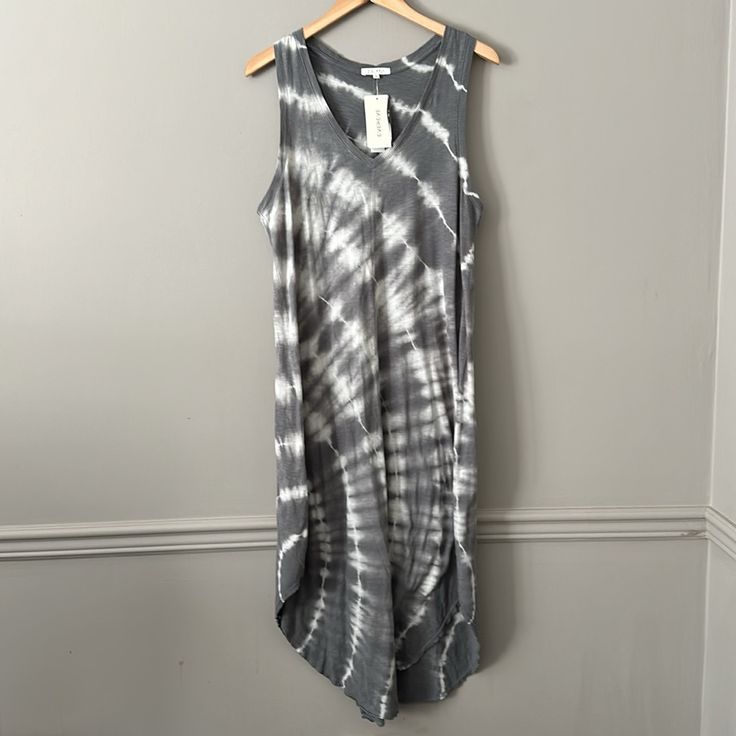 a black and white tie dye top hanging on a wall