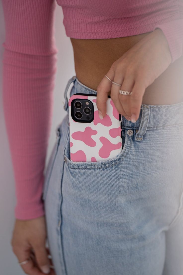 a woman is holding her cell phone in the back pocket