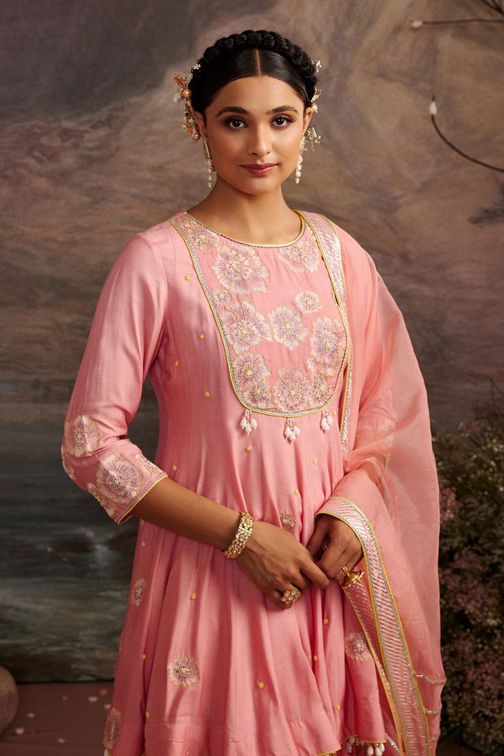 Rose pink short circular sharara with floral embroidered motifs and bead drops. Comes with shimmer sharara and dupatta.
Component: 3
Pattern: Embroidery
Type Of Work: Gota Patti and Beads
Neckline: Round
Sleeve Type: Three Quarter
Fabric: Cotton Silk and Organza
Color: Pink
Other Details: 
Dupatta with gota patti trims on the border and tassels
Bead drops on the hem
Occasion: Wedding - Aza Fashions Kurta Sharara Set, Organza Embroidery, Kurta Sharara, Short Kurta, Embroidered Motifs, Tarun Tahiliani, Beaded Neckline, Sharara Set, Pattern Embroidery