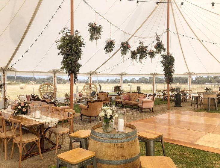 the inside of a tent with tables and chairs