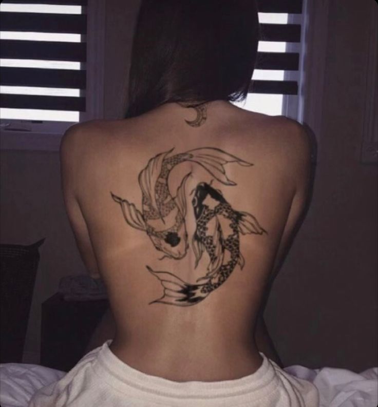 a woman with a tattoo on her back