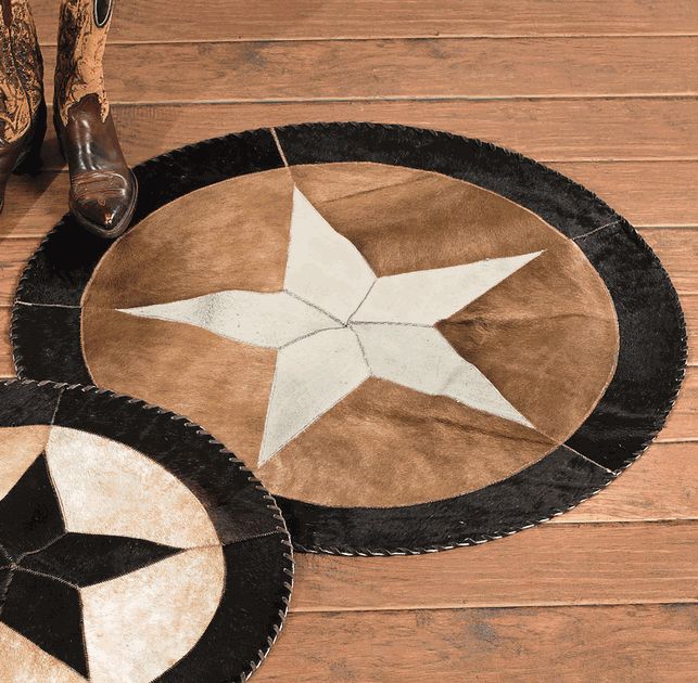 two black and white rugs on wooden floor with one star in center, the other round