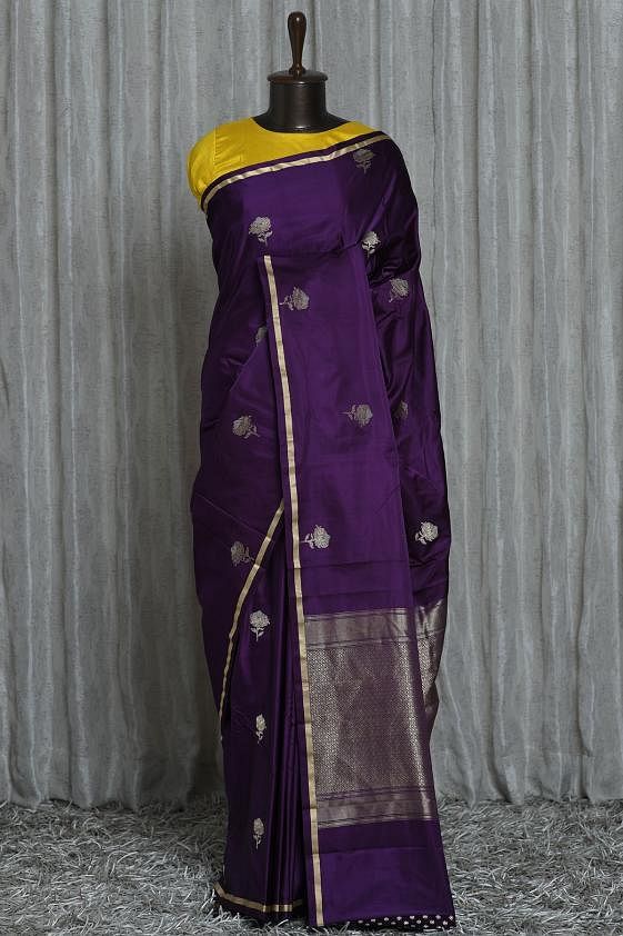 Define your presence elegantly by draping this Dark Purple color silk saree at your upcoming occasion, completely decorated with aesthetic rose motifs laced in gleaming zari looks enticing. Its broacde pallu adds additional detail to the saree appeal. Accompanied with a matching color zari embellished butti detailed blouse piece. The silk fabric ensures crisp and smart appearance. There might be a little color variation in the image and original product due to photographic lighting sources or yo Dark Purple Combination Outfits Indian, Purple Sari With Contrast Blouse, Purple Color Saree With Contrast Blouse, Brinjal Colour Saree Contrast Blouse, Dark Purple Saree Contrast Blouse, Wine Color Saree Contrast Blouse, Brinjal Colour Saree, Purple Saree Blouse Designs, Contrast Blouse For Purple Silk Saree