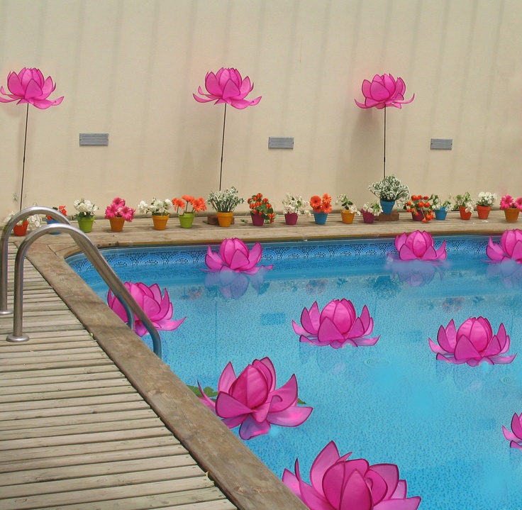 a pool with pink flowers floating in it