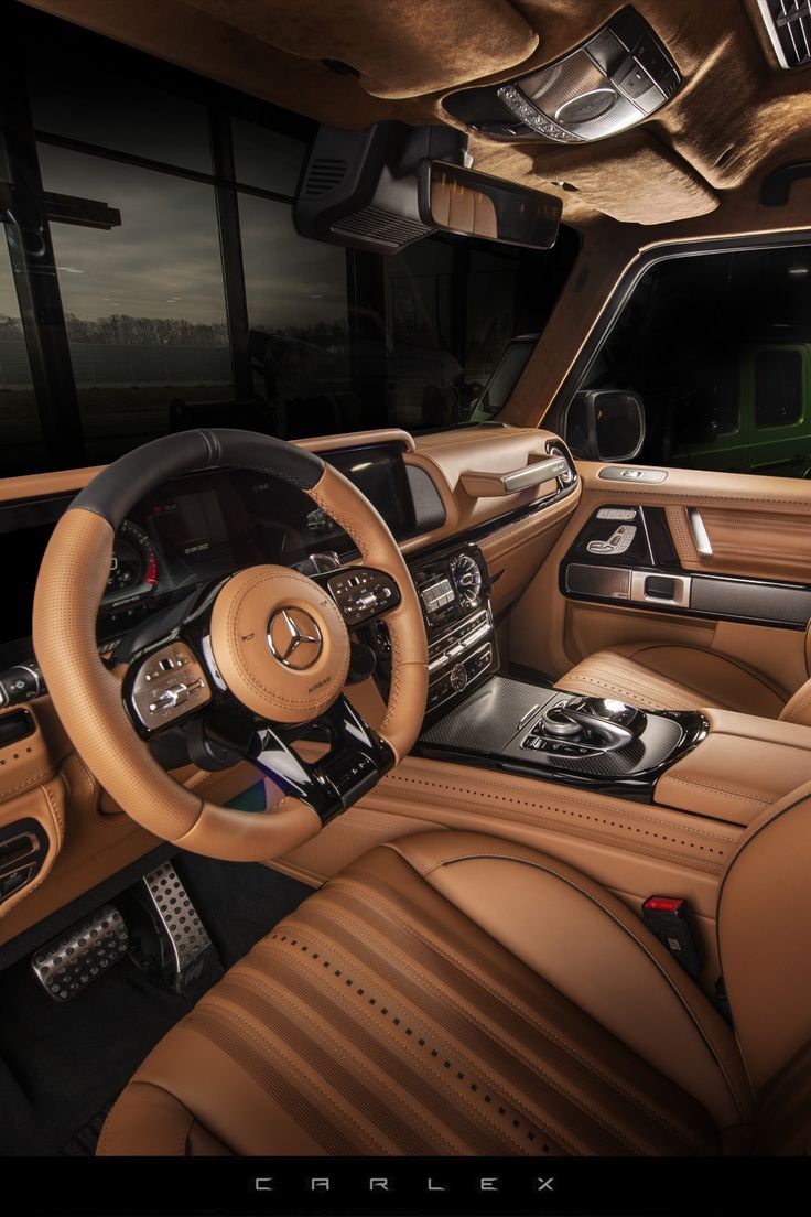 the interior of a luxury car with leather and wood trims, steering wheel and center console