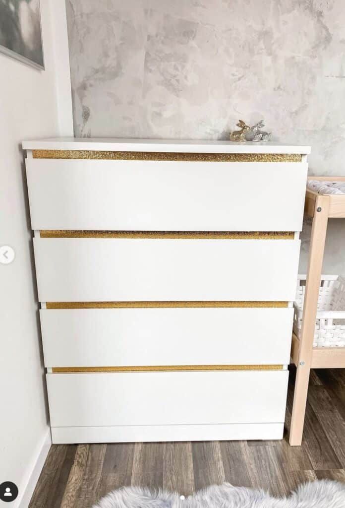 a white and gold dresser in a bedroom