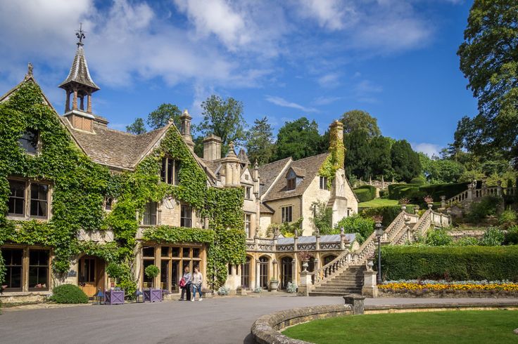 an old mansion with ivy growing on it's walls