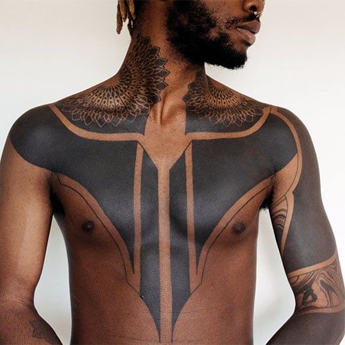 a man with tattoos on his body and chest