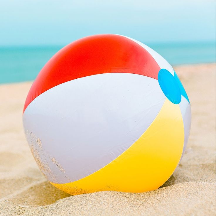 an inflatable beach ball sitting on the sand