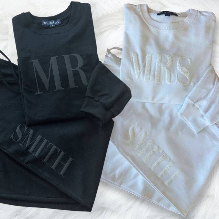 two sweatshirts with mr and mrs on them sitting on a white furnishing