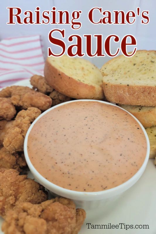 a white plate topped with fried food and dipping sauce next to two pieces of bread