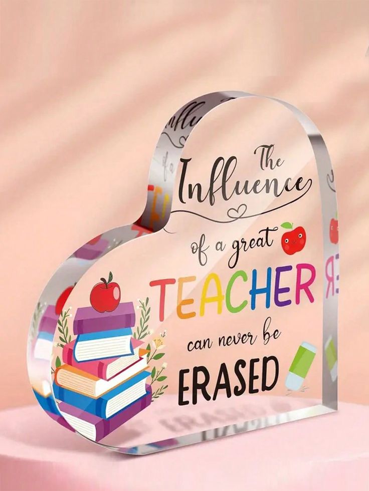 a clear acrylic sign with an apple and books on it that says, the influence of a great teacher can never be erase