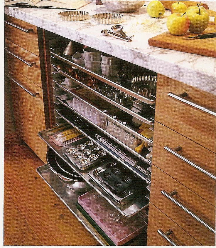 an open drawer in a kitchen filled with lots of food and utensils on the counter