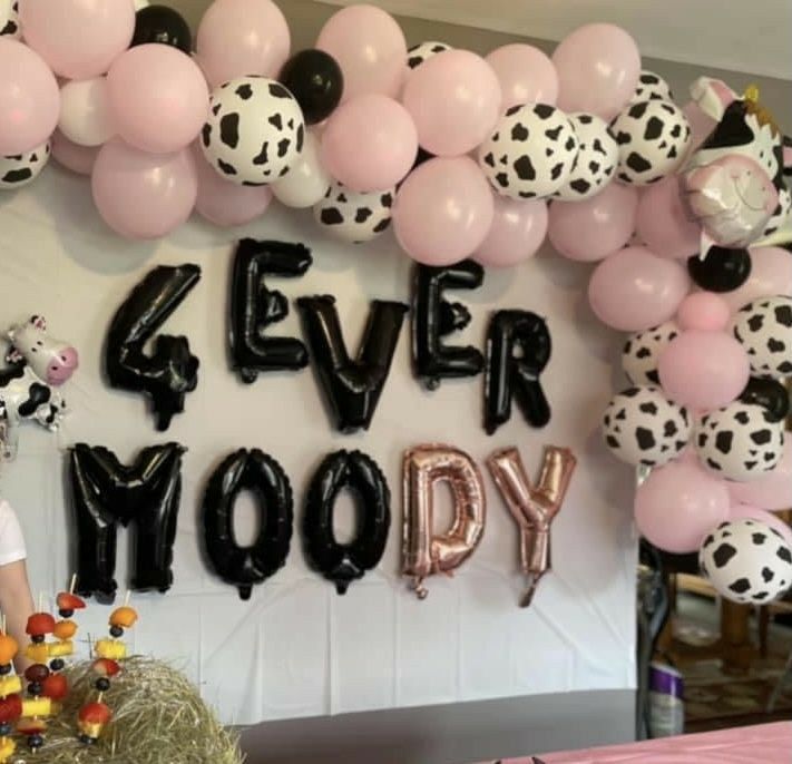 a birthday party with balloons and decorations for the 4 ever moo - dy