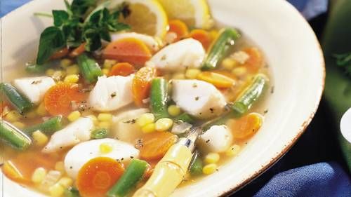 a white bowl filled with soup and vegetables