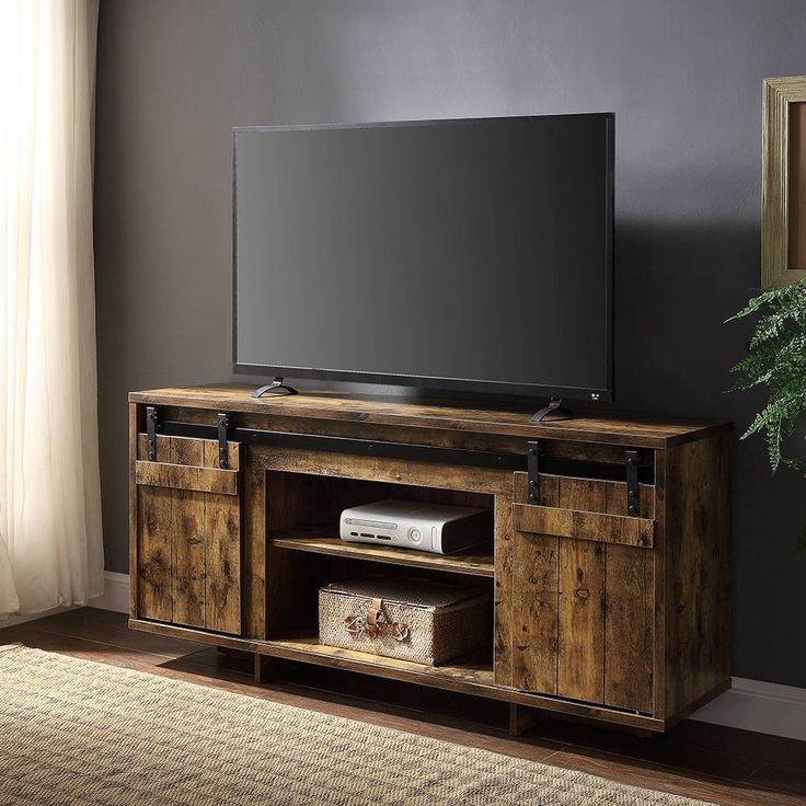 an entertainment center with sliding doors and a flat screen tv mounted on it's side