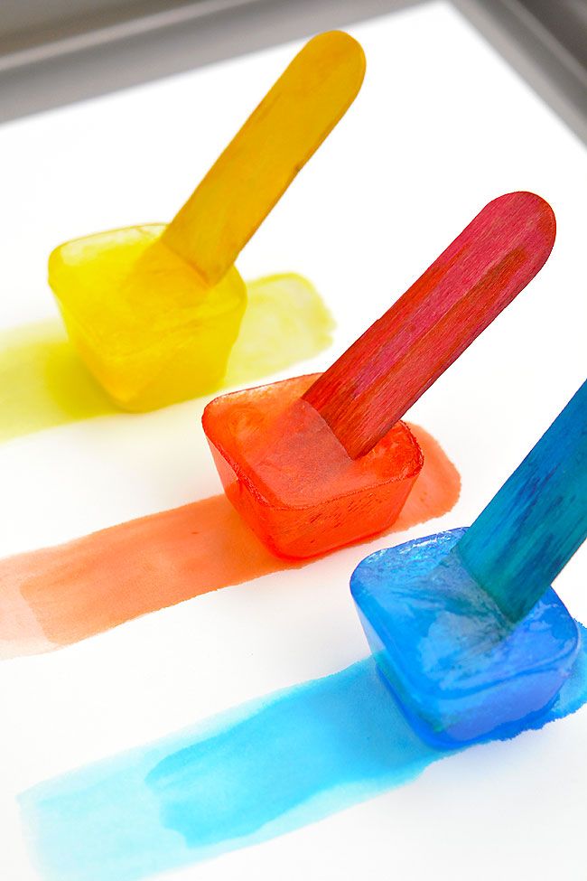 three popsicles are sitting on top of each other with different colored sticks sticking out of them