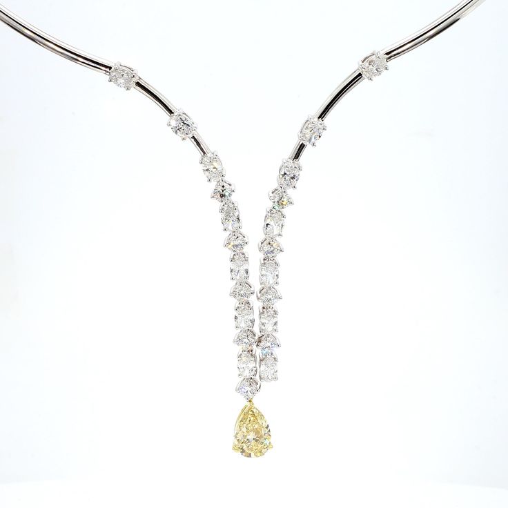 RareGemWorld's classic yellow diamond necklace. Mounted in a beautiful 18K Yellow and White Gold setting with a natural pear cut yellow diamond. The yellow diamond is surrounded by natural round cut white diamonds and natural oval cut white diamonds. This necklace is guaranteed to impress and enhance your personal collection. Total Weight: 5.92cts  Natural Fancy Light Brownish Yellow Pear Cut Diamond Measurement: 9.98 x 6.79 x 4.48 mm Carat Weight: 2.03cts Clarity Grade: SI2 Natural Oval Cut Whi Yellow Diamond Necklace, Brownish Yellow, Fancy Light, Fancy Lights, White Gold Set, Pear Cut Diamond, Pear Diamond, Yellow Diamond, Pear Cut