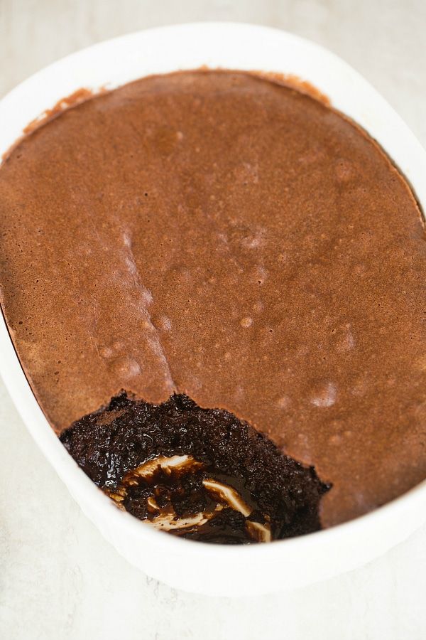 a chocolate cake in a white bowl on a table