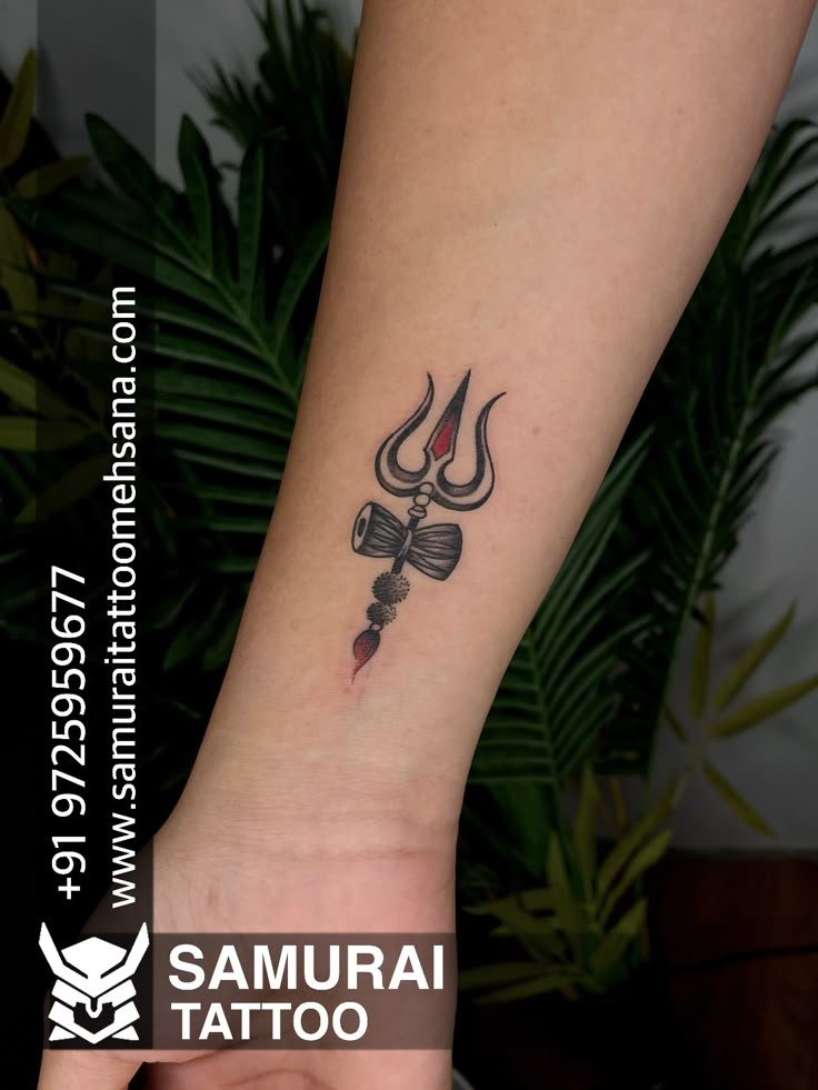 a tattoo on the arm of a woman with a devil's head in it