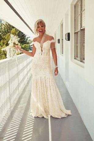 a woman in a wedding dress is standing on a porch with her hand out to the side