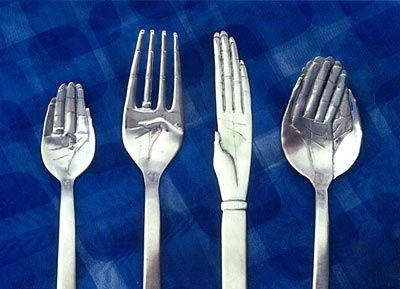 four forks and two knives on a blue background