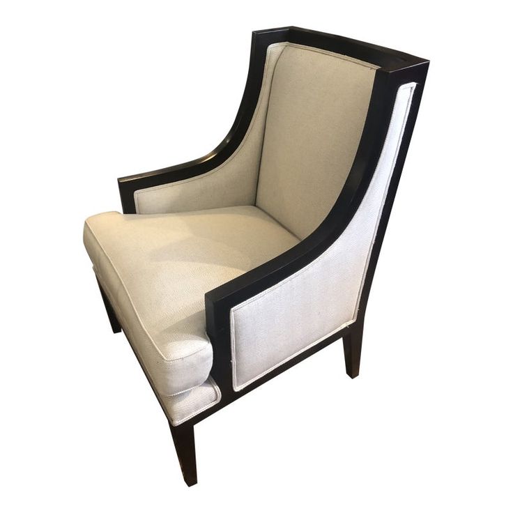 an upholstered chair with black and white trim on the back, sitting against a white background