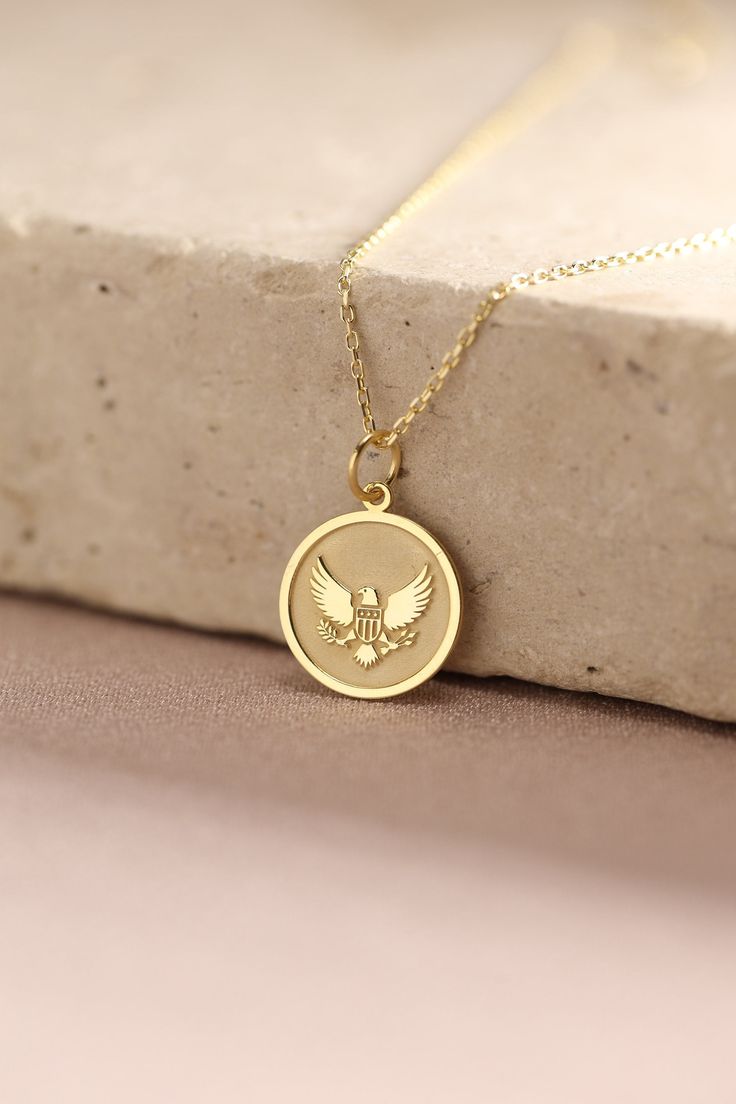 Gold Eagle Pendant - Eagle Gold Necklace ● Material of pendant: Solid Gold 14k ( REAL GOLD ) ● Metal Stamp: 14k ( REAL GOLD ) ● The pendant is available in 5 sizes: - 12,7 mm / 0.5 inches (Diameter) - 14,0 mm / 0,55 inches ( Diameter ) In the photos - 15,3 mm / 0.6 inches ( Diameter ) - 16,5 mm / 0,65 inches ( Diameter ) - 19,1 mm / 0,75 inches ( Diameter ) ( In the photos the size is 14mm / 0.55 inches Diameter ) ( Jump Ring inner diameter: 4 mm ) ● Material of chain: Solid gold 14k ( REAL GOLD Symbolic Charms Necklaces For Commemoration, Commemoration Charms Necklace With Round Pendant, Symbolic Charms Necklace For Commemoration, Commemoration Pendant Necklaces With Charms, Commemorative Pendant Necklaces With Charms, Commemorative Pendant Necklace With Charms, Tarnish Resistant Pendant Charm Necklace For Anniversary, Spiritual Yellow Gold Jewelry For Birthday Gift, Spiritual Yellow Gold Jewelry For Birthday