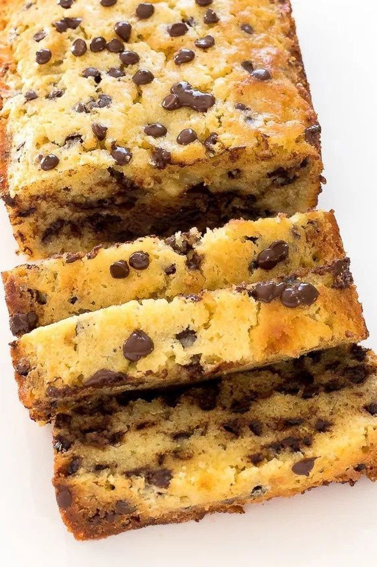 three slices of chocolate chip bread on a white surface